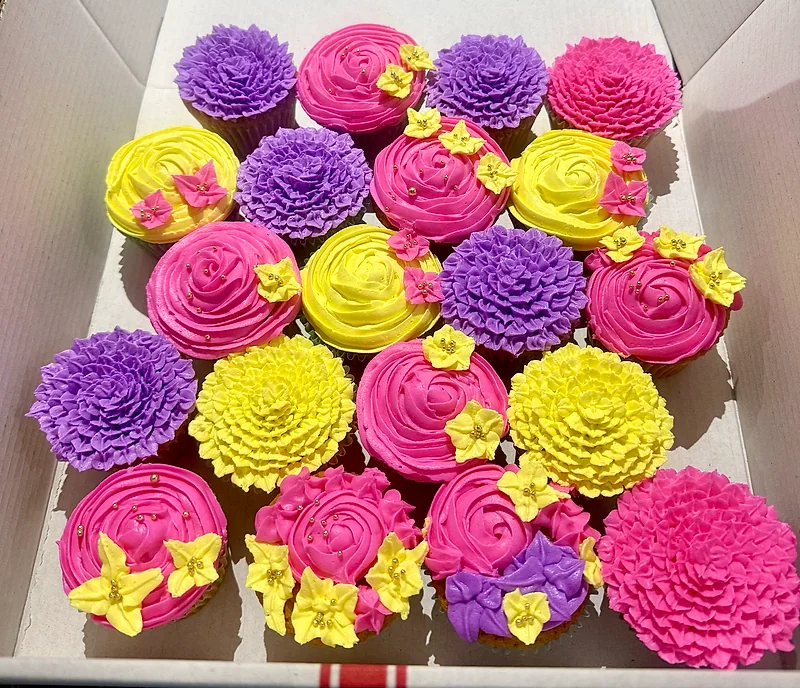 Pink, yellow and purple floral cupcakes by Mimi’s Sweet Creations