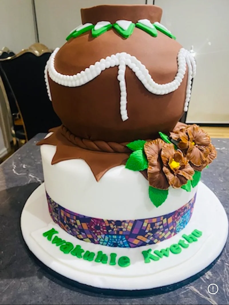 Brown and white two-tier celebration cake with floral decorations